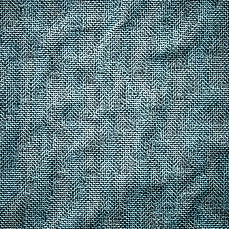 Close-up of woven fabric texture, mix of metals in a tight, uniform pattern.