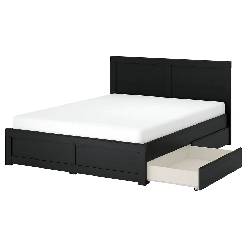 Black oak FÅGELFJÄLLET bed with storage drawers, sleek design, white mattress.