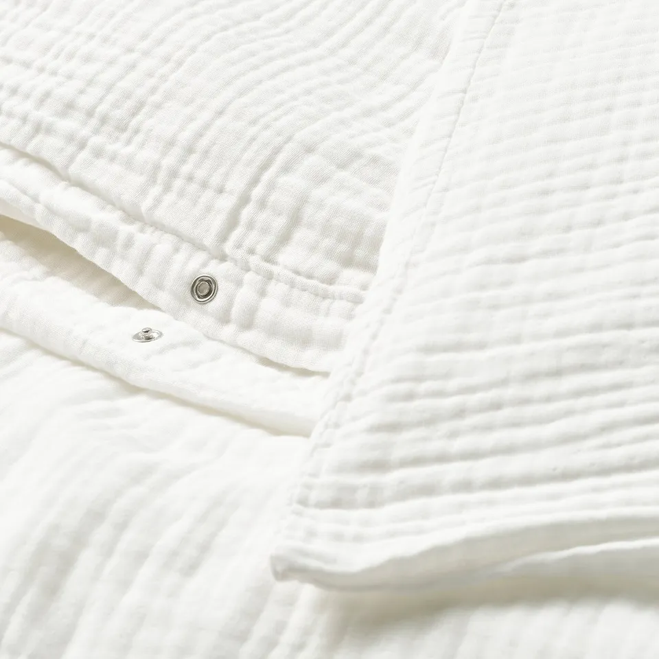 White bedding set with press-stud closure, soft organic cotton, breathable muslin fabric.