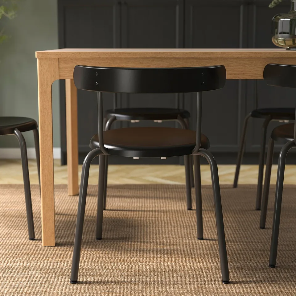 Modern dining chair with rounded back, easy to stack and hang on table, ideal for easy cleaning and efficient space use.