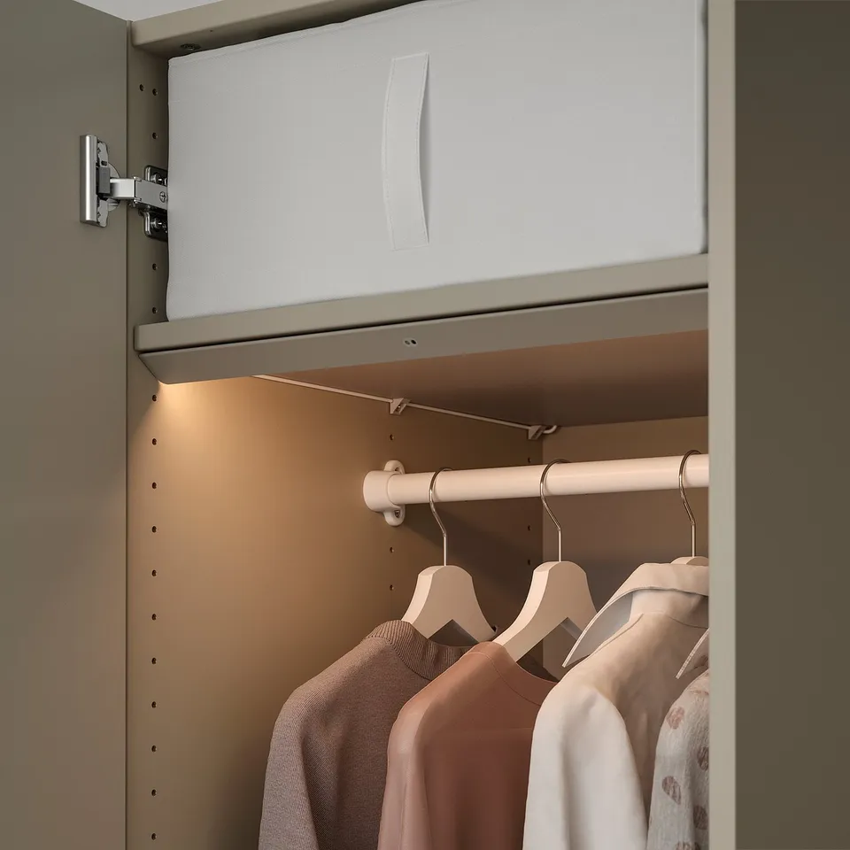 Modern closet with led lights illuminating clothes.