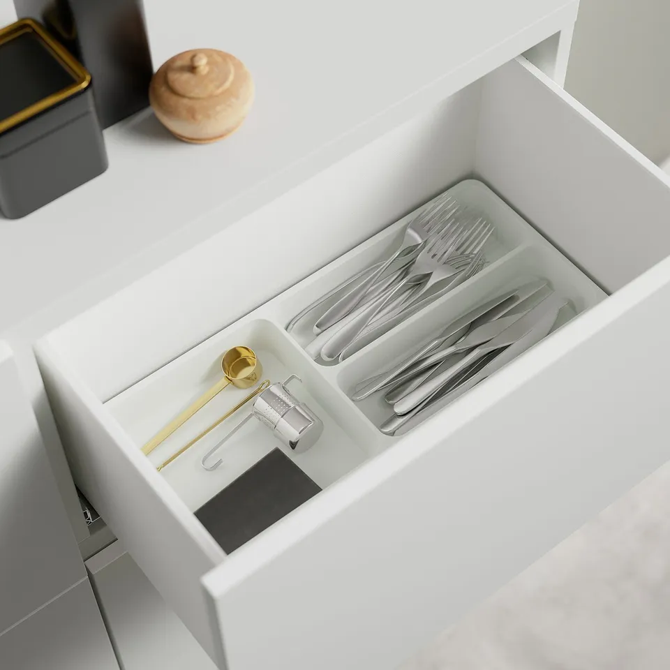 Open drawer shows organised cutlery: forks, knives, spoons, chopsticks, and measuring spoon in adjustable compartments.
