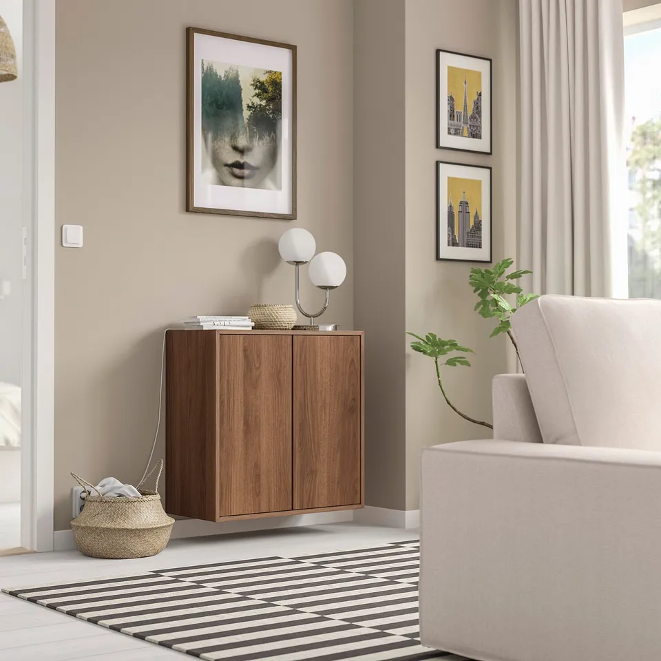Modern room with wooden EKET cabinet, striped rug, couch, art, floor basket.