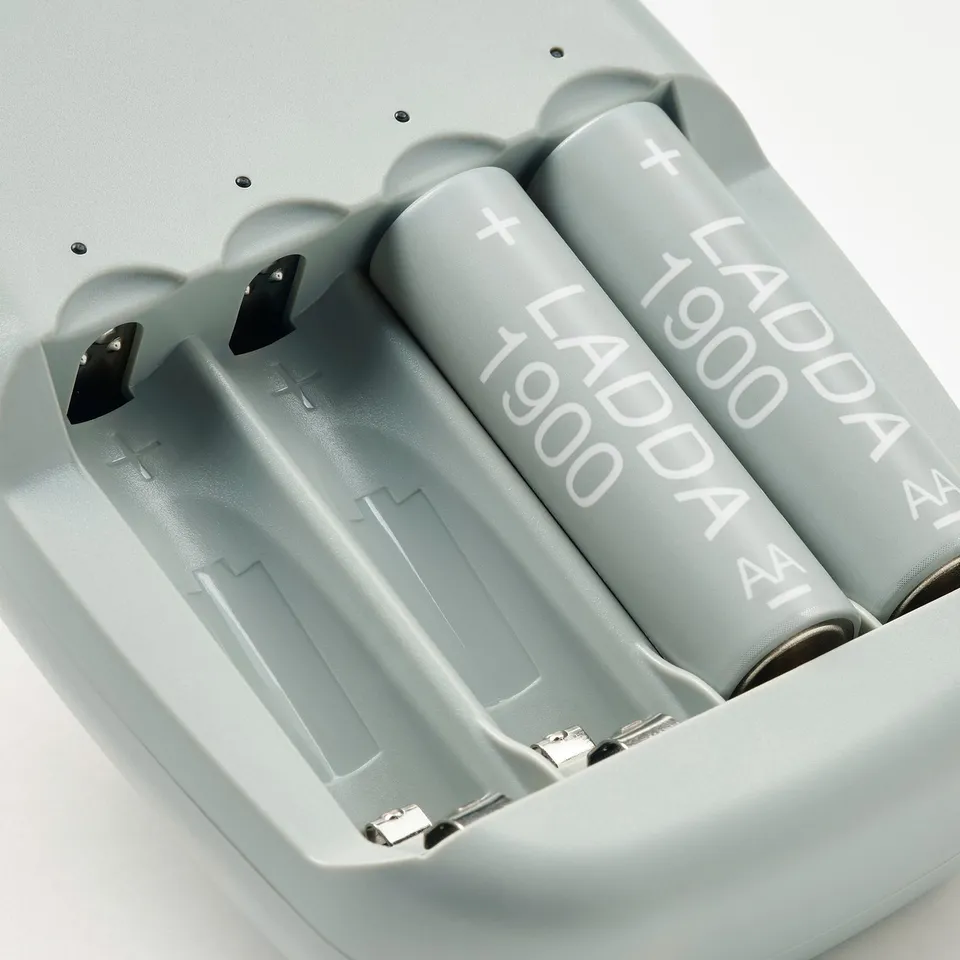 Close-up of four ladda rechargeable batteries in STENKOL charger, showcasing high-quality design and precision engineering.
