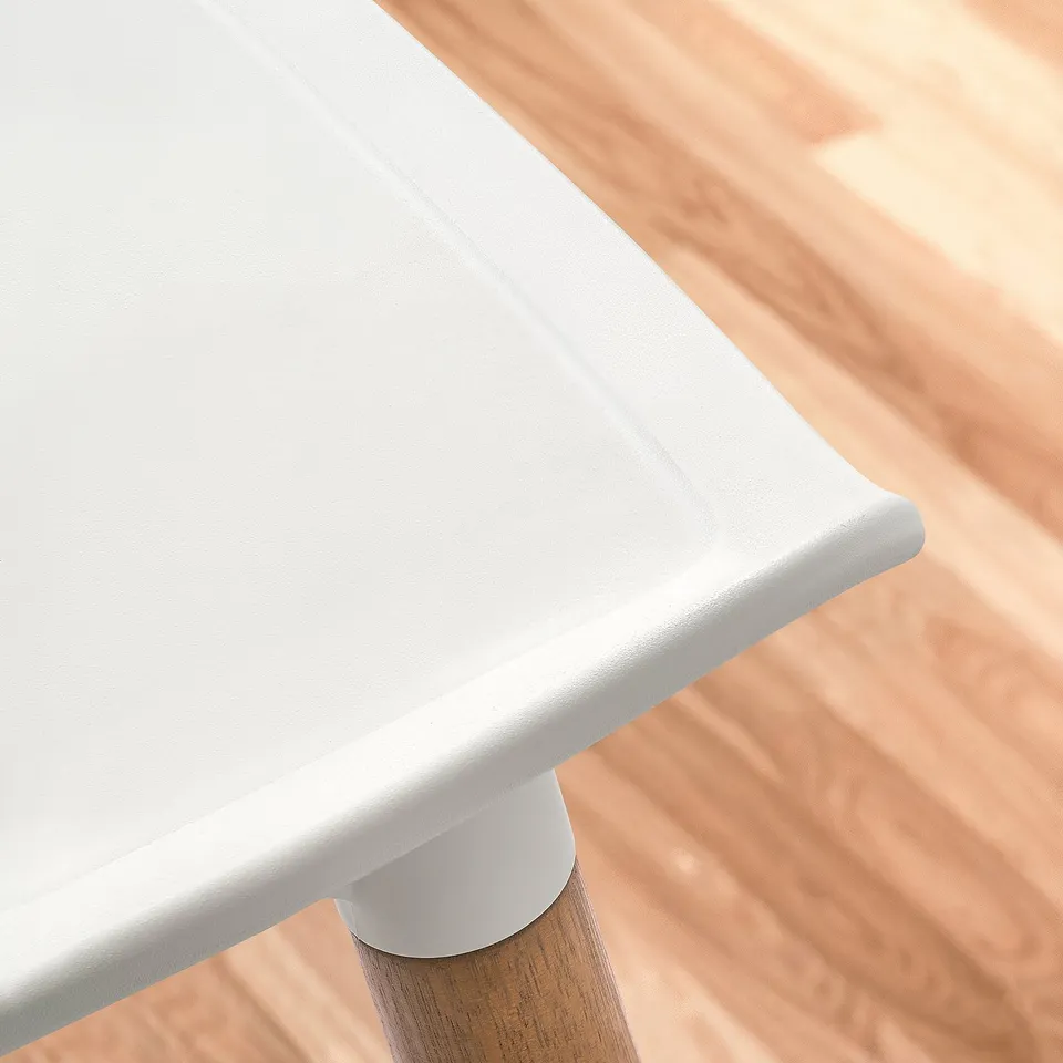 Modern table with white smooth top and sleek wooden leg. High-quality and minimalist design.