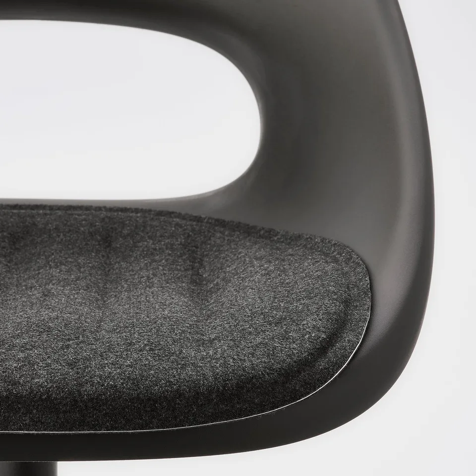 Close-up of modern black desk chair, showing soft seat pad and adjustable design.