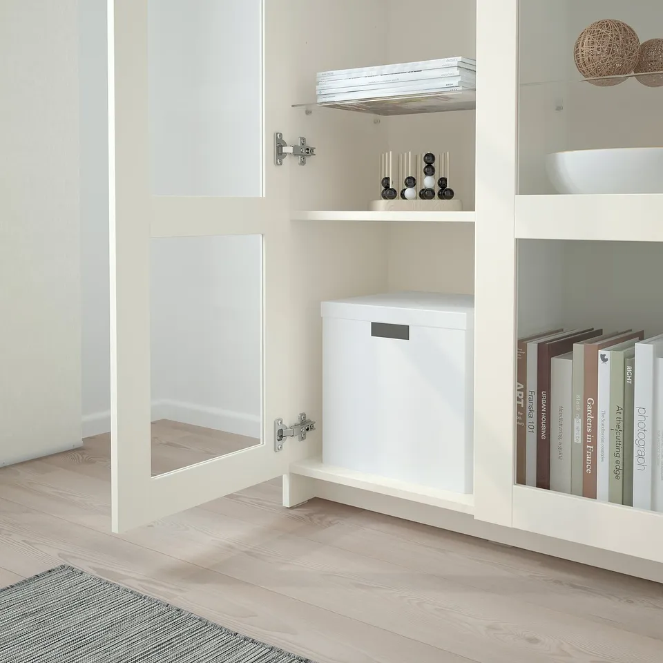 White BRIMNES shelving unit with storage boxes and books.