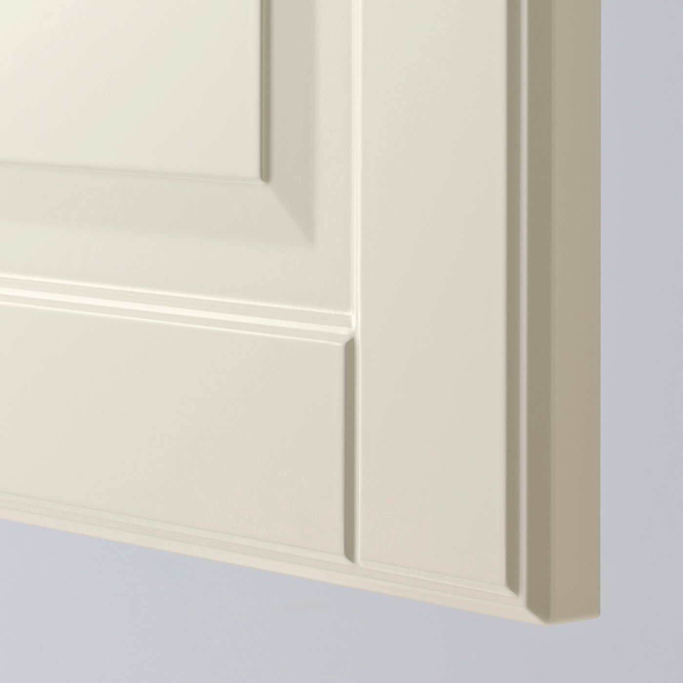 Close-up of high-quality METOD kitchen cabinet with off-white bodbyn fronts, smooth finish, bevelled edges on white background.