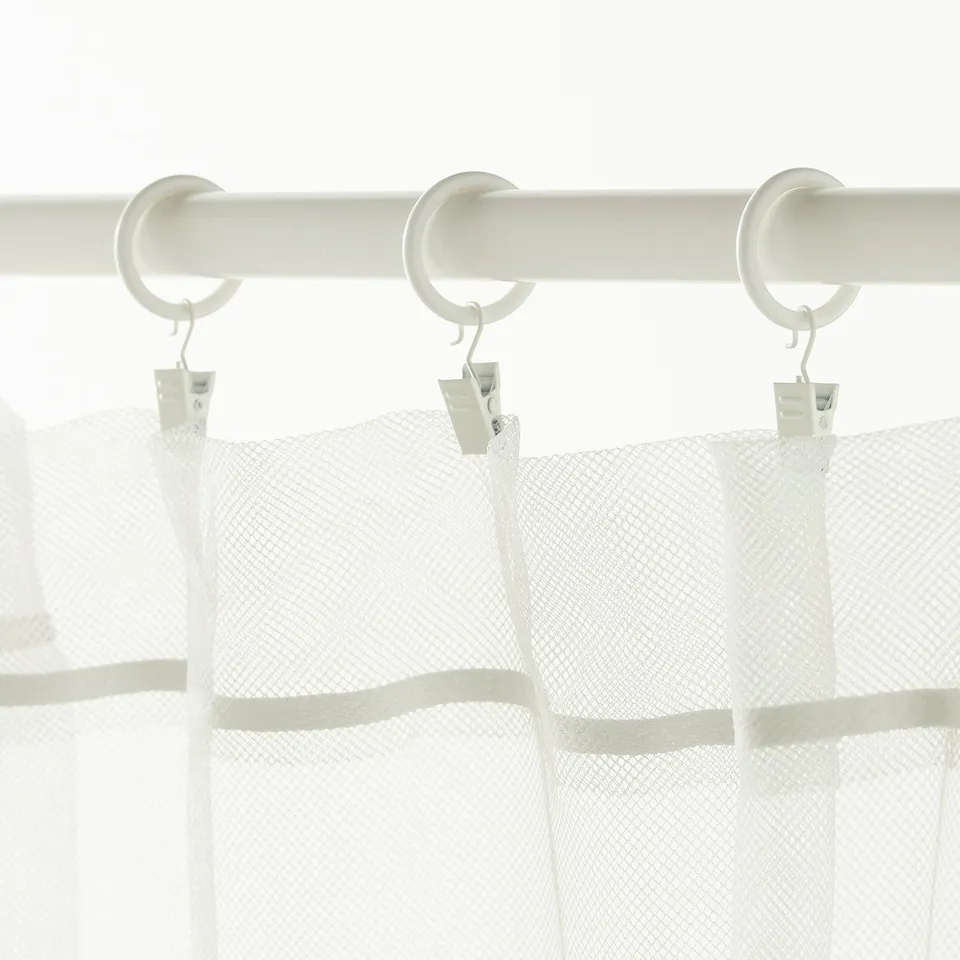 White curtain rings with clips, hanging sheer white curtains.