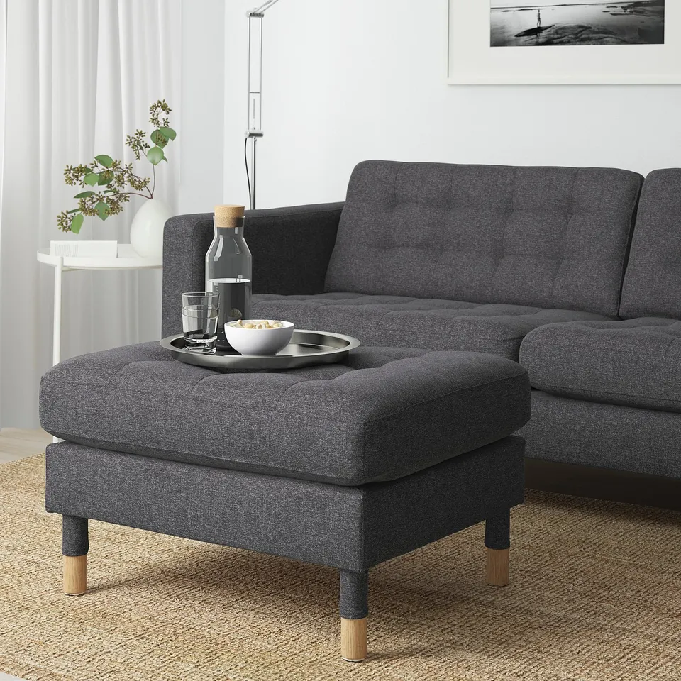 Grey LANDSKRONA footstool in living room with food tray.