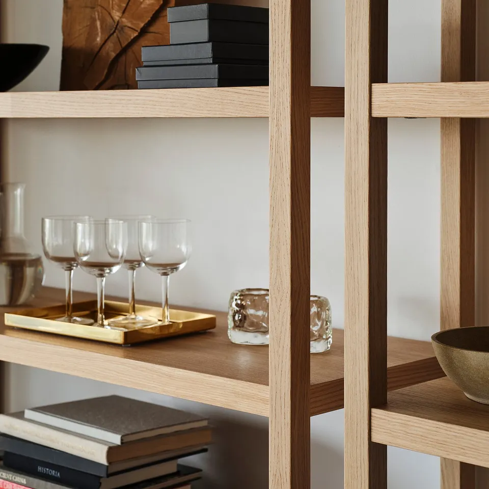 Wooden shelves with glasses, books, and candles. Wall-fixed.