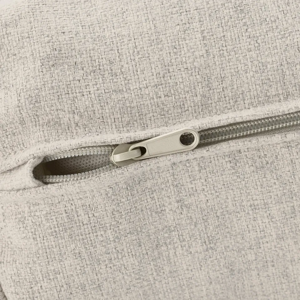 Close-up of a zip on a fabric surface, showcasing quality design and construction.