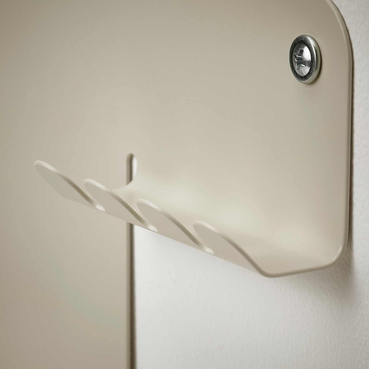 Magnetic wall organiser with a small shelf, attaches securely to wall.