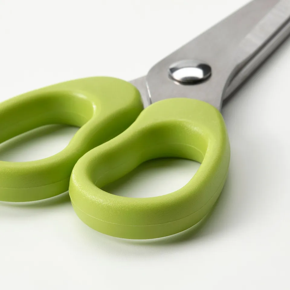 Pair of green-handled scissors with stainless-steel blades, child-safe design.