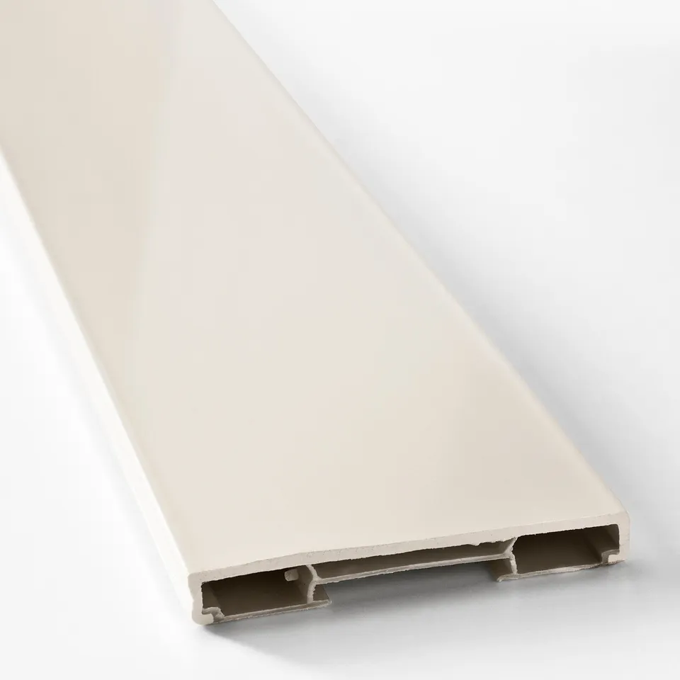 A sleek, white plastic plinth lying on its side, showing clean edges and clips for easy attachment.