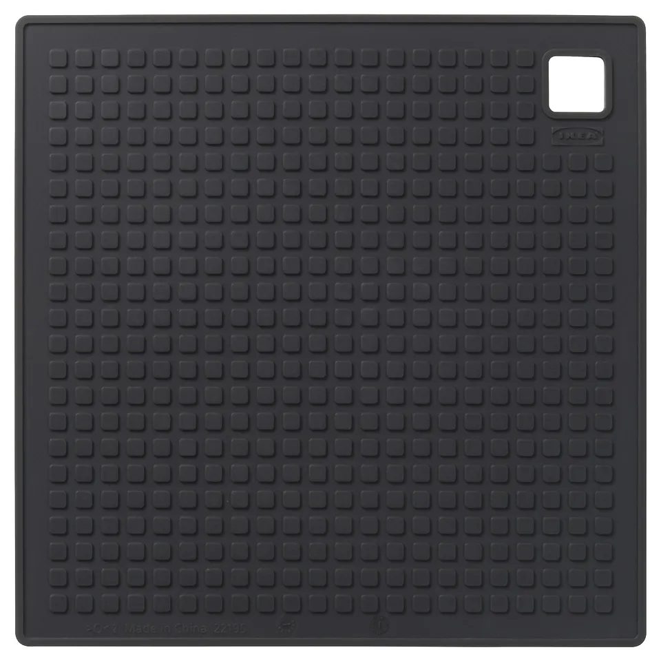 The SANDVIVA black silicone trivet; square with textured surface and hanging hole, ideal for kitchen use.
