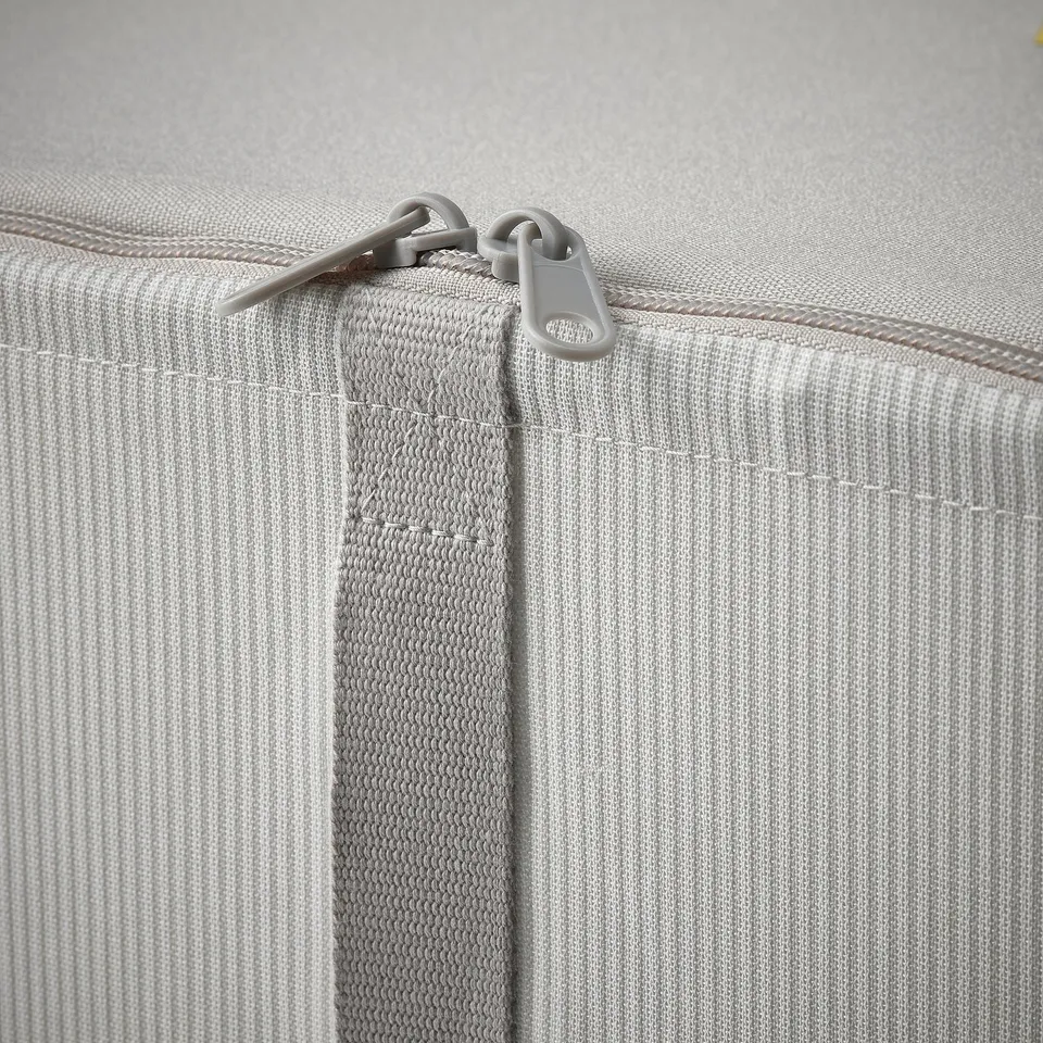 Close-up of durable, light grey fabric storage box with high-quality zip and sturdy connectors.