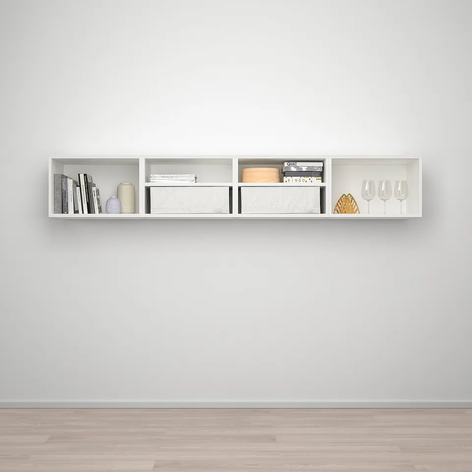 A white, modern wall-mounted shelf, PLATSA, holds books, vases, and glasses neatly on a grey wall.