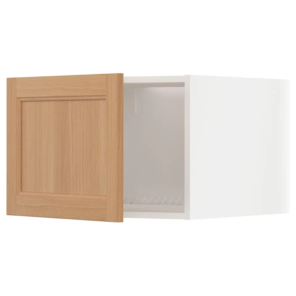 Light wood cabinet door opens to white fridge/freezer top.