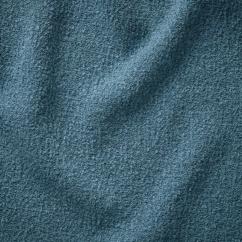 Close-up of UPPÅKRA sofas soft, textured bouclé fabric, showcasing its plush, inviting quality.