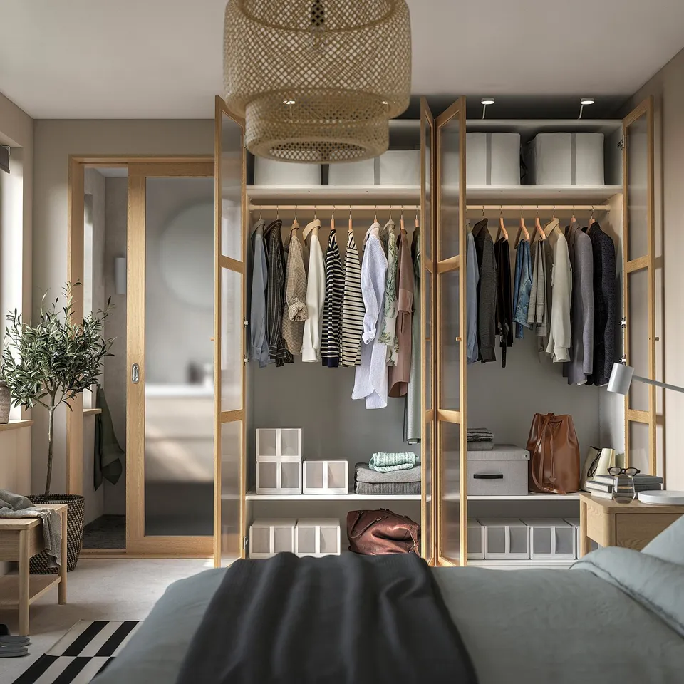Modern wardrobe with hanging clothes, shelves, and a stylish pendant light. Part of an organised bedroom suite.