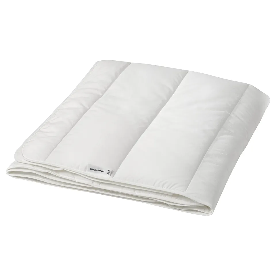 A white SKOGSFRÄKEN duvet folded neatly. Its soft, breathable, and made from recycled polyester and lyocell. Perfect for warm seasons.