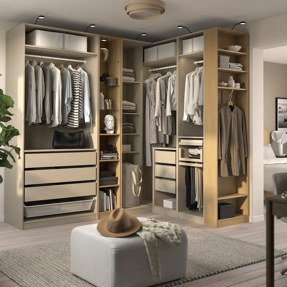Modern walk-in closet with hanging clothes, shelves, drawers, and built-in lighting. PAX wardrobe system for efficient organisation and storage.