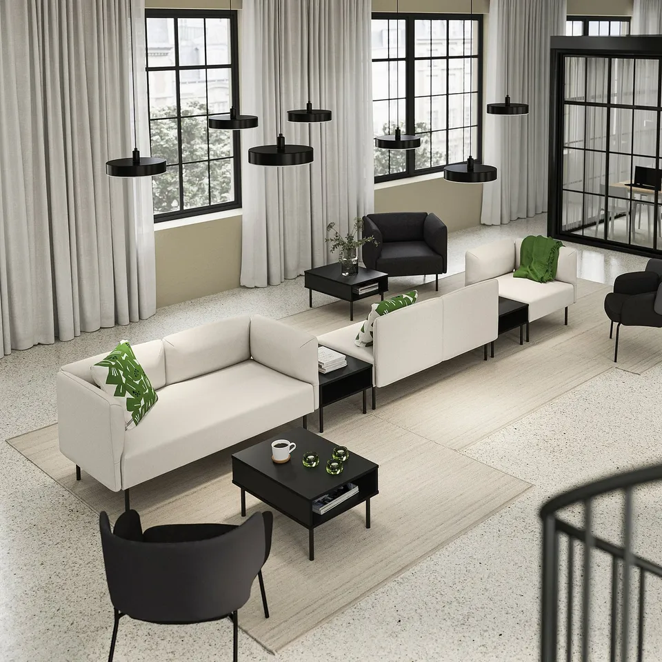 Modern living room with LILLEHEM white sofa, black chairs, coffee table, large windows, and green pillows.