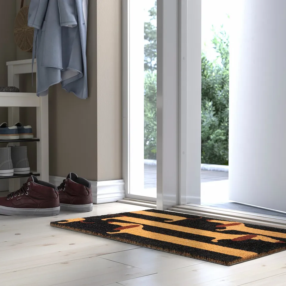 ARBETSTÅG doormat with striped coir pattern at doorway.