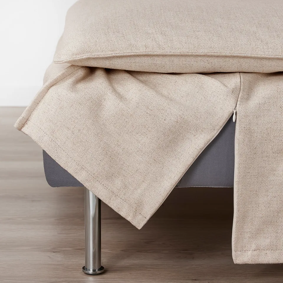 Beige sofa section with zip on light wood floor.
