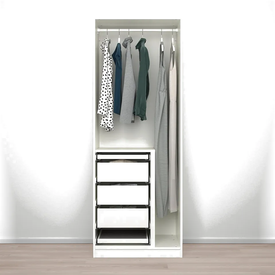 A compact PAX wardrobe with drawers, trays, and a clothes divider, displaying hanging garments.