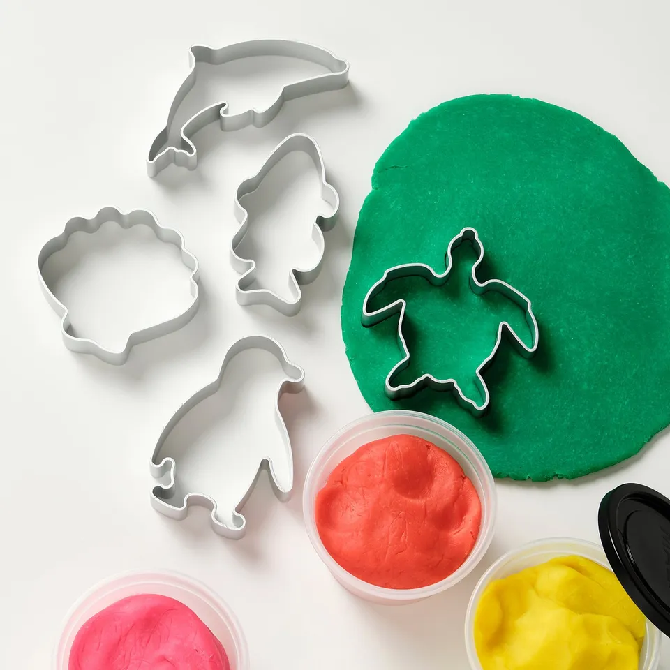 Playdough set with sea creature cutters for kids to develop fine motor skills and creativity.