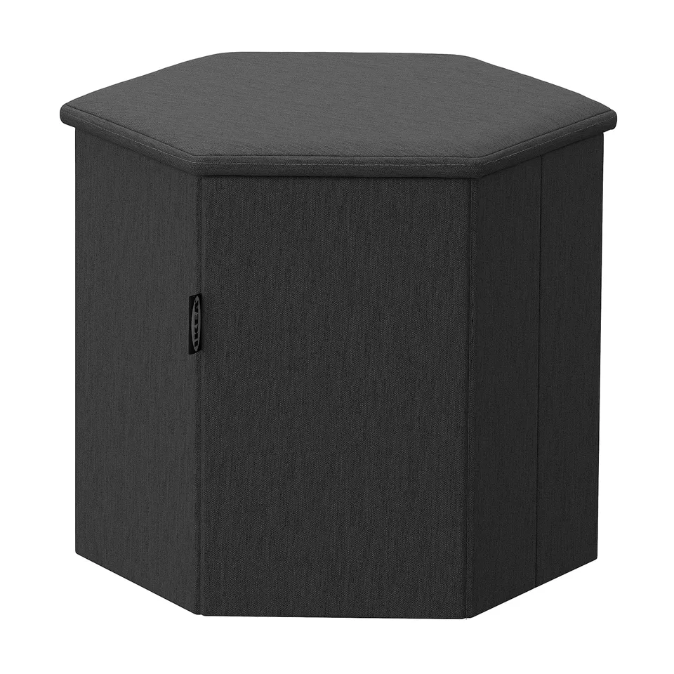 Hexagonal black fabric storage ottoman with padded seat and hidden compartment.