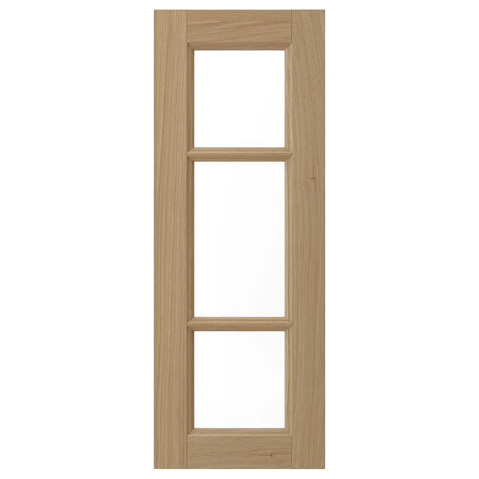 A VEDHAMN oak cabinet door with three glass panels, sleek and rustic.