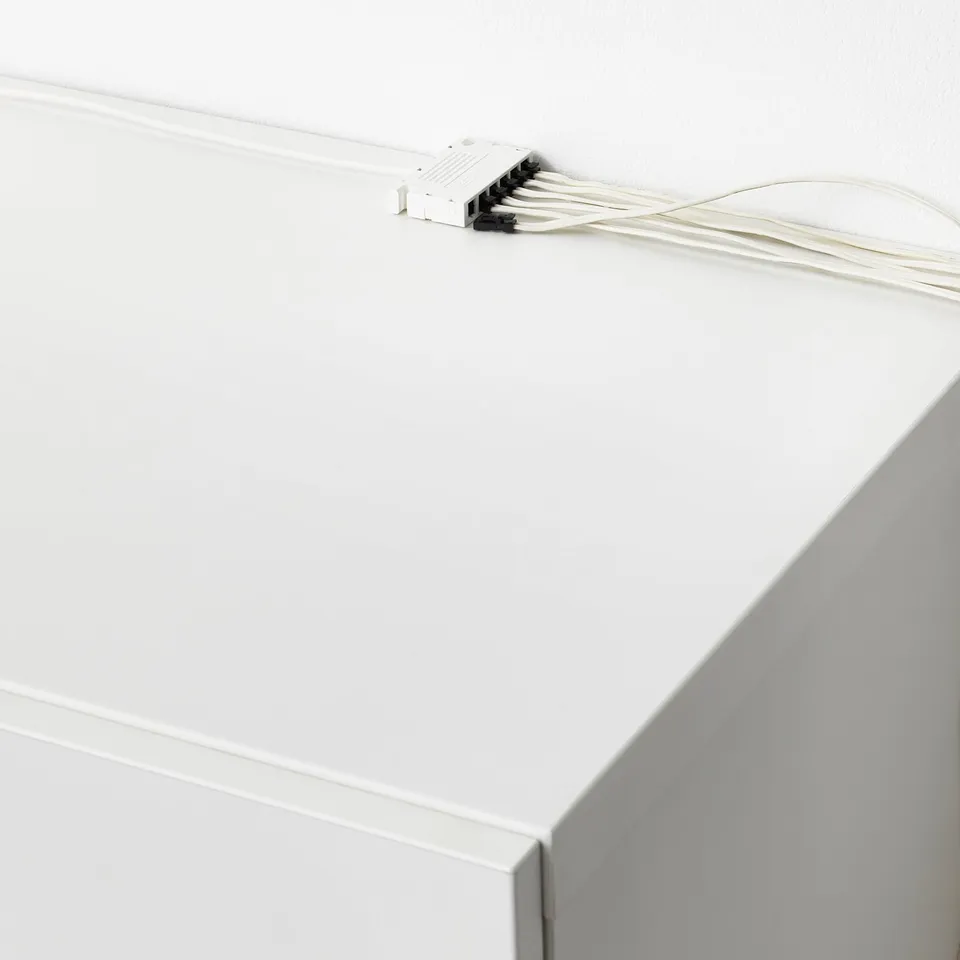 White wall switch controls multiple lights via visible cords.