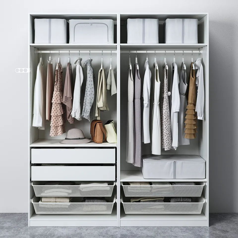 Organised wardrobe with clothes hangers, drawers, baskets, and storage boxes for efficient clothing management.