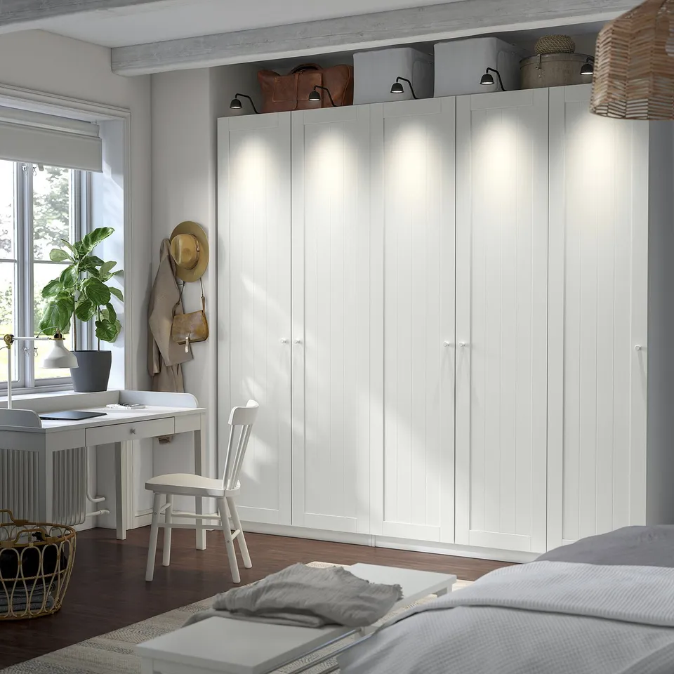 White PAX wardrobe, desk, and plants.