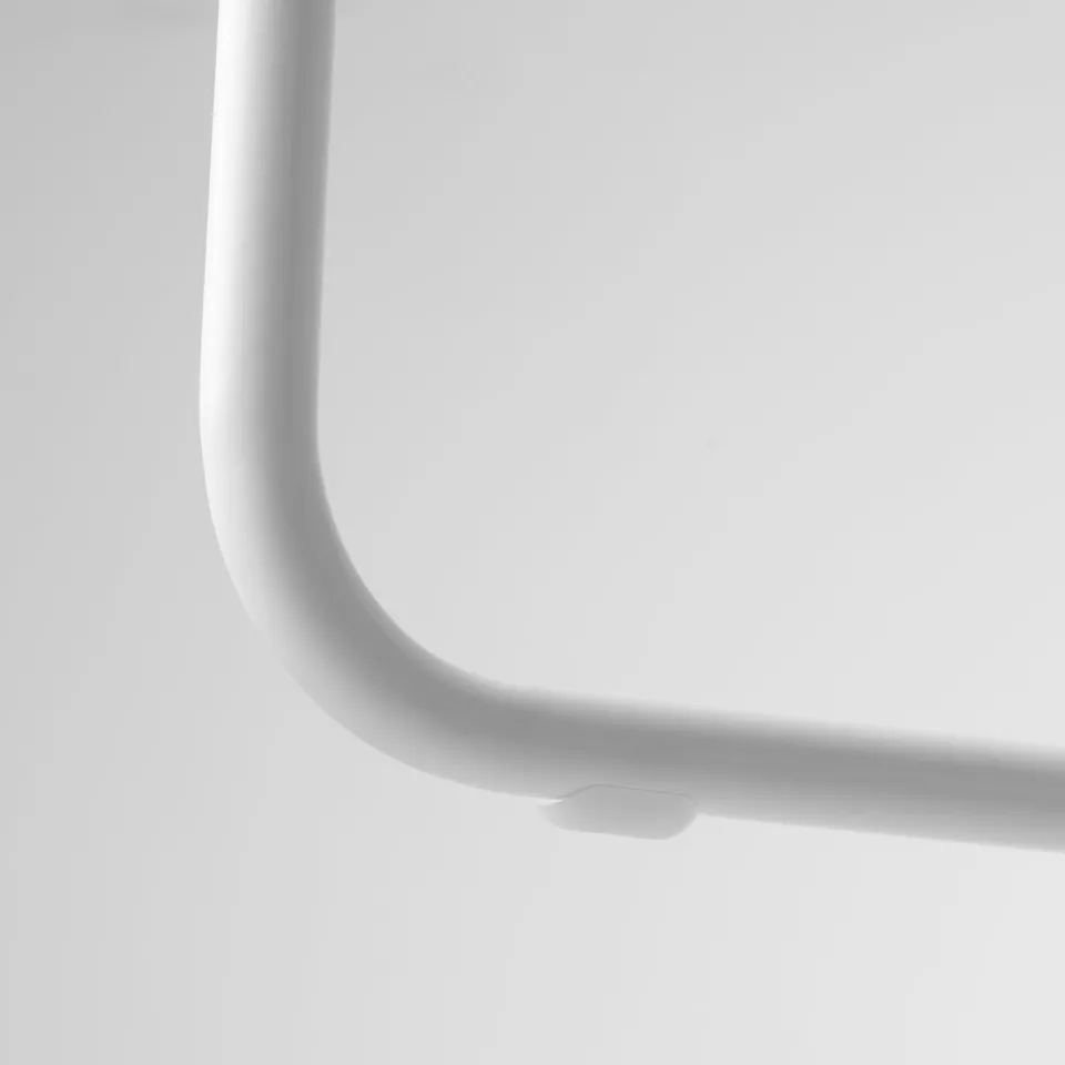 Closeup of sleek, modern table leg with smooth, glossy finish and subtle handle detail.
