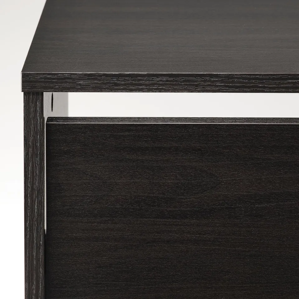 Black wooden furniture piece with smooth finish and clean edges, showing close-up detail of craftsmanship.