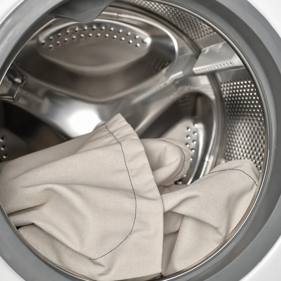 Washing machine drum with microfiber cushion for cleaning or maintenance.