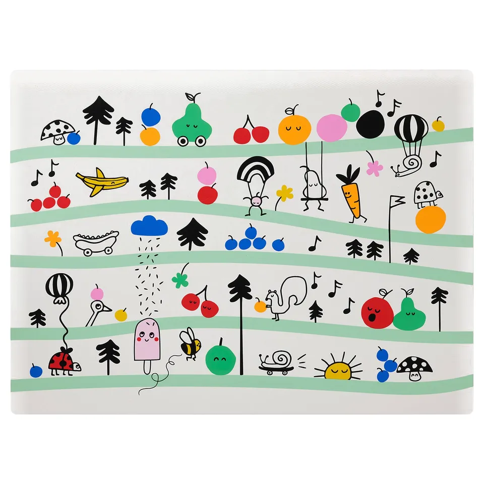 A colourful, square GRÖNFINK place mat with playful designs of fruits, animals, and musical notes, ideal for childrens learning and mealtime fun.